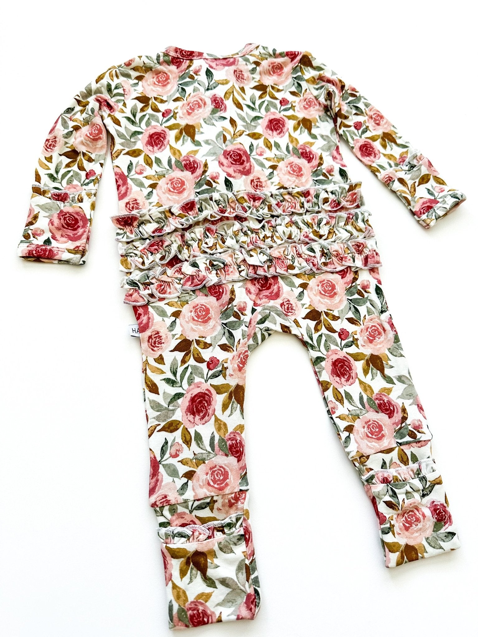 Dusty pink floral bamboo ruffle baby outfit with 2-way zipper, fold-over feet and hand cuffs for babies.