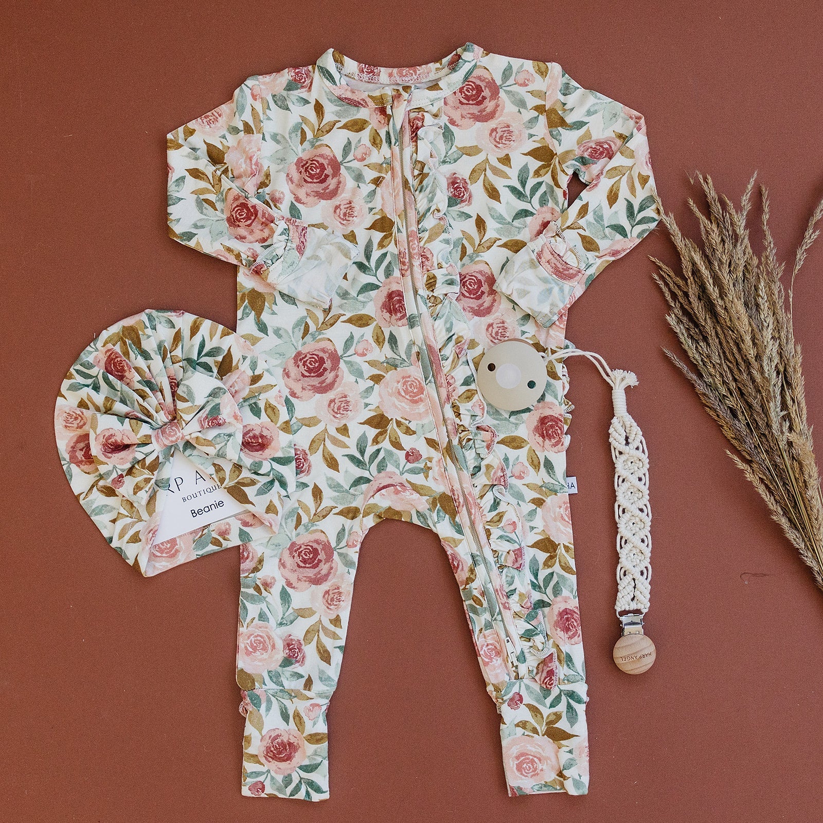 Dusty pink floral bamboo ruffle baby outfit with 2-way zipper, fold-over feet and hand cuffs for babies.