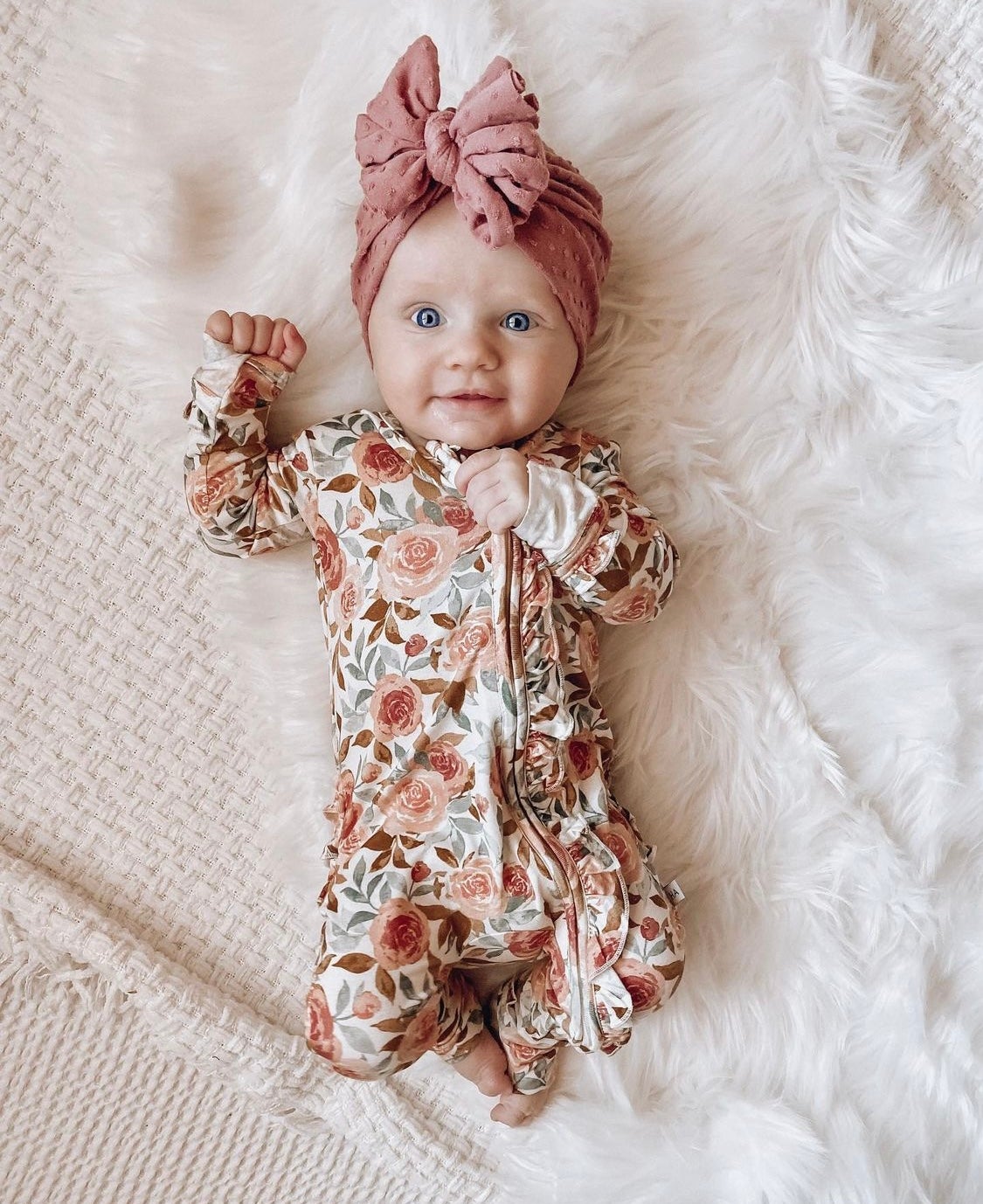 Dusty pink floral bamboo ruffle baby outfit with 2-way zipper, fold-over feet and hand cuffs for babies.